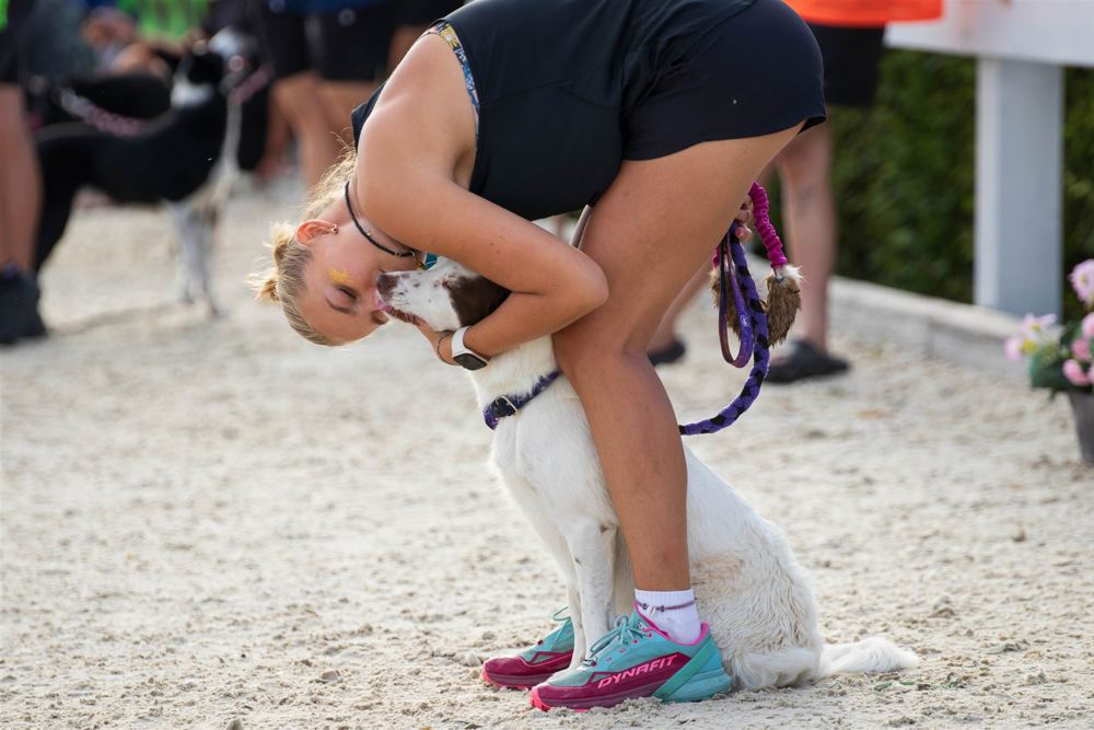 Competitor hugging dog